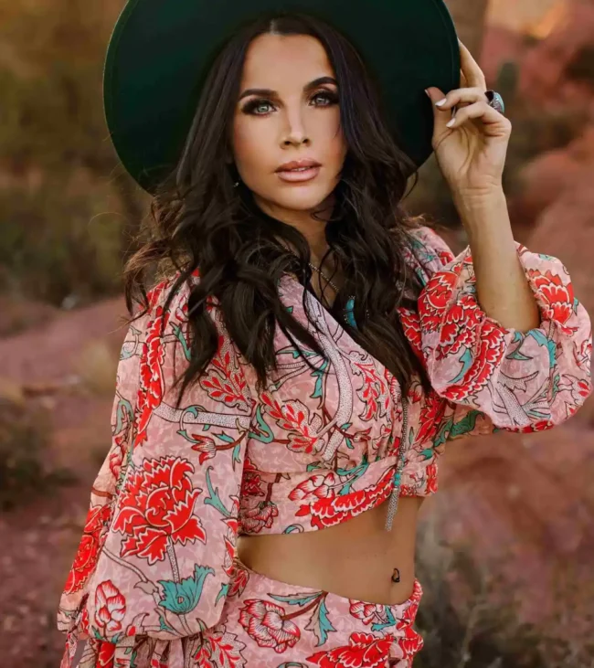 a woman wearing a hat and a crop top Danielle-Boldon-Owner-Tabu-Salon