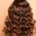 Professional hair color correction results showing healthy, shiny, wavy brown hair from the back in Scottsdale, AZ