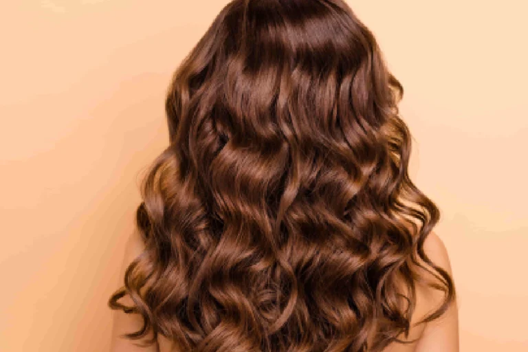 Professional hair color correction results showing healthy, shiny, wavy brown hair from the back in Scottsdale, AZ